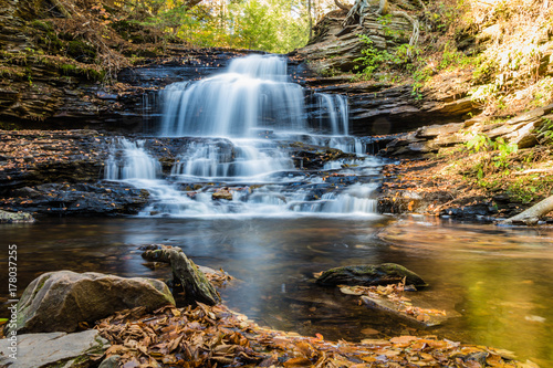 Waterfalls are surrounded by colorful fall foliage at Ricketts Glen State Park in Benton, PA