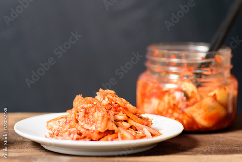 Korean food, kimchi cabbage on white dish and a jar with chopsticks for eating.Healthy food