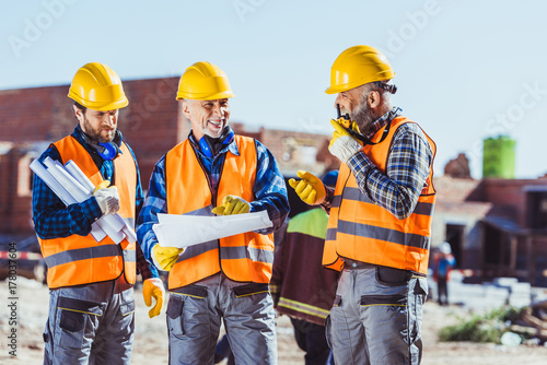 workers examining building plans