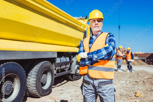Construction worker with arms crossed
