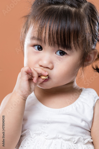 Cute baby girl eating snack