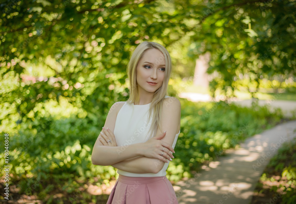 Outdoors portrait of beautiful young woman in the park. Selective focus.