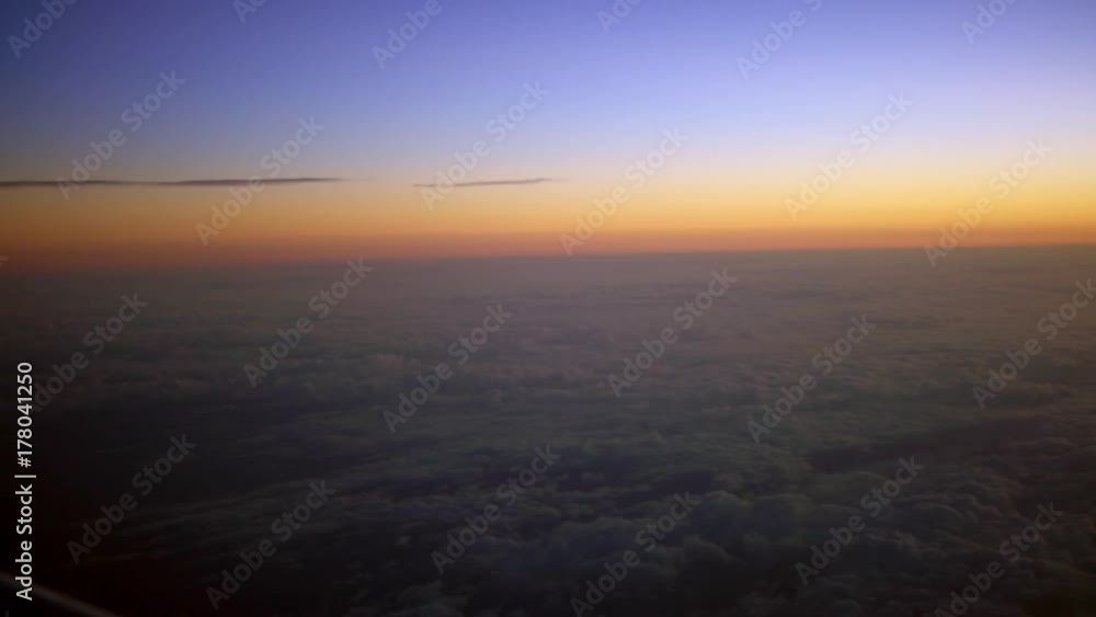 4K Traveling by air. Beautiful view of the sky and clouds with the sun from above, as seen through an airplane window in dawn sun-Dan 4K Traveling by air. Beautiful view of the sky and clouds with the sun from above, as seen through an airplane window in dawn sun-Dan