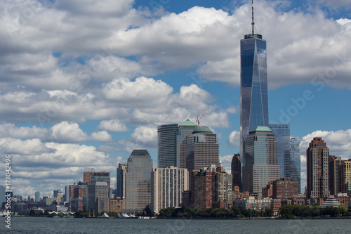 Urban New York American  landscape from ocean (among water) with skyscrapers and blue sky with contrast clouds on background