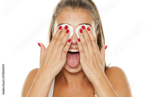 Bilde på lerret young beautiful woman removing makeup from her face