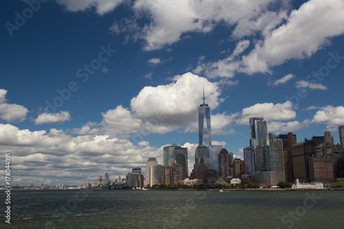 Urban New York American  landscape from ocean  among water  with skyscrapers and blue sky with contrast clouds on background