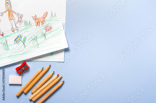 Children's drawing and color pencils top view photo