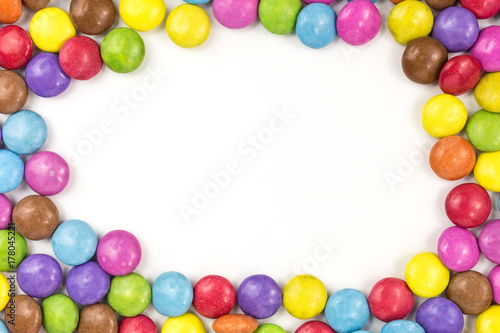 background of multicolored sugar coated candies with copyspace