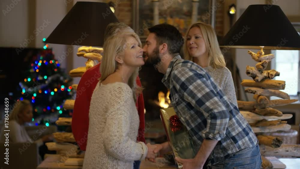 Happy family at Xmas, parents meeting daughter's boyfriend for 1st time Happy family at Xmas, parents meeting daughter's boyfriend for 1st time