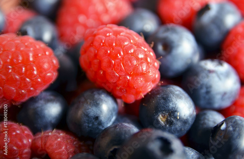Fresh blueberries and raspberries as a background.Blueberry and raspberry close up.Healthy eating,diet and nutrition concept.Selective focus.