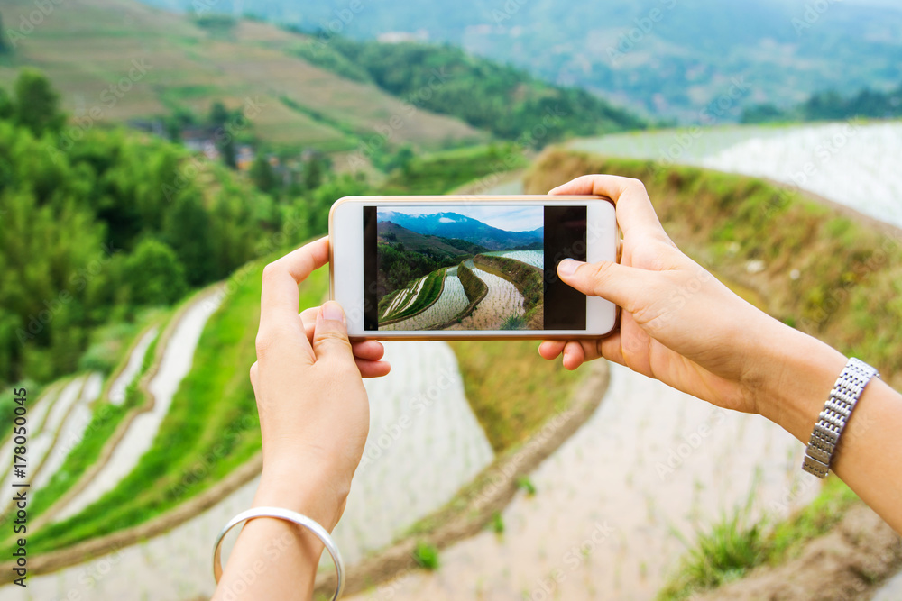 Girl capturing rice terrace scenery with a phone Girl capturing rice terrace scenery with a phone