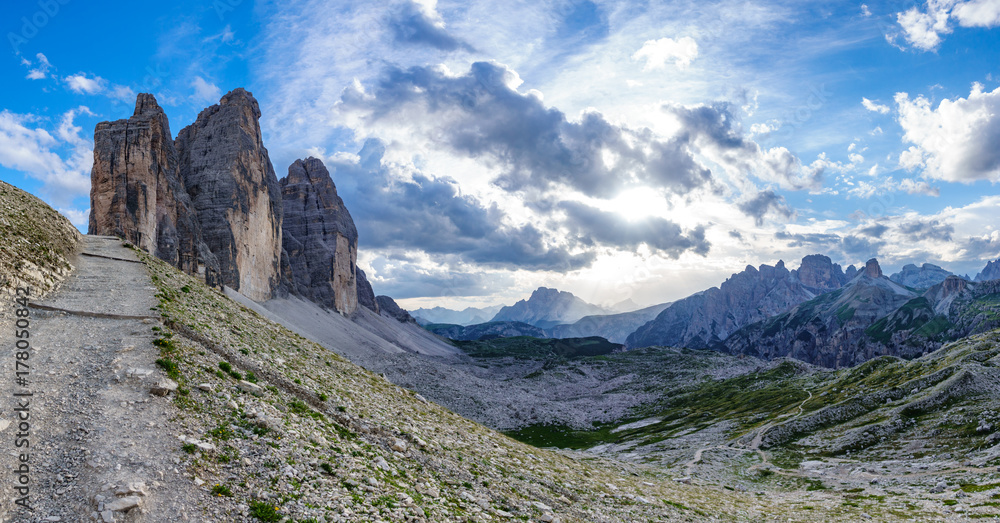 Tre Cime di Lavaredo rocks big panorama at sunset with track Tre Cime di Lavaredo rocks big panorama at sunset with track