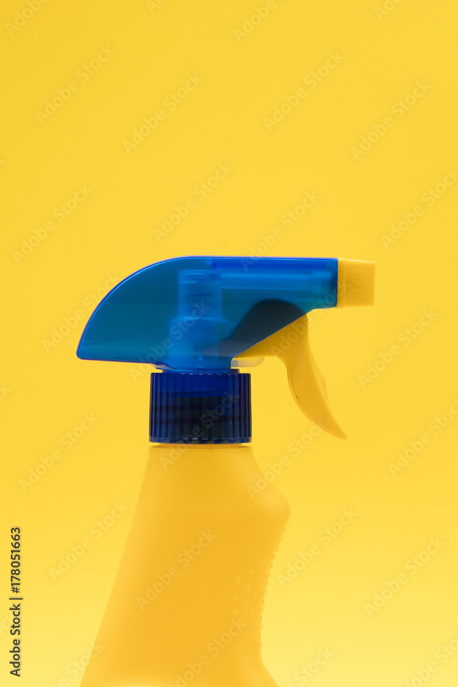 Cleaning spray bottle products on a bright yellow background Cleaning spray bottle products on a bright yellow background