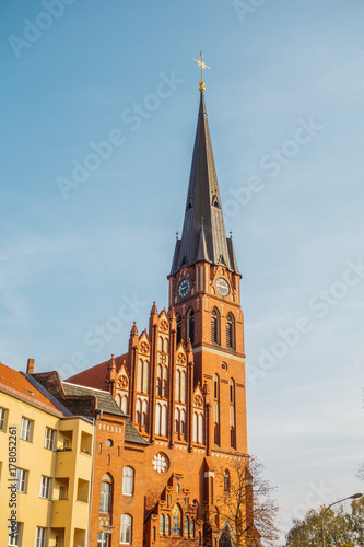 high format picture of clock tower from red church