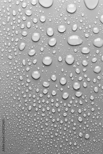 Surface with water drops, grey background. © Allusioni