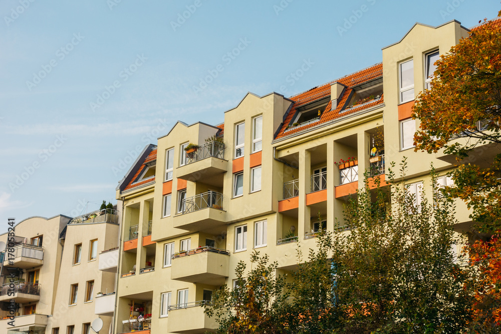 Fototapeta premium typical apartment buildings framed by trees