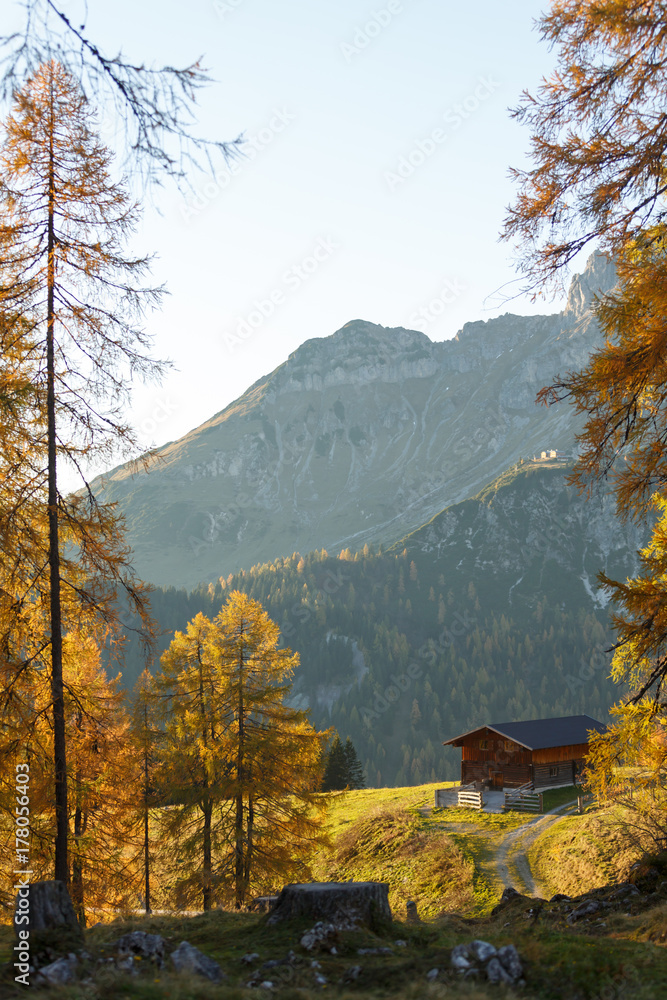 Wooden cottage in the Alps. Autumn landscape