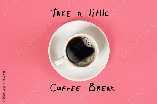 Top view of cup of black coffee and Take a little coffee break lettering isolated on pink background