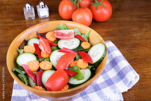 Large Mixed Salad in Wood Bowl with Fresh Tomatoes