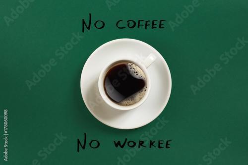 Top view of cup of black coffee and No coffee No workee lettering isolated on green background