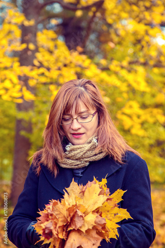 Portrait of woman in an autumn park.