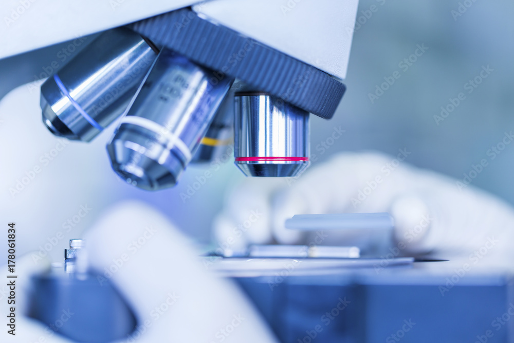 Scientist hands with microscope, examining samples Scientist hands with microscope, examining samples