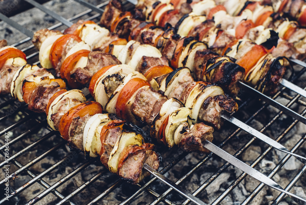Shashlik cooked on a barbecue grill over charcoal