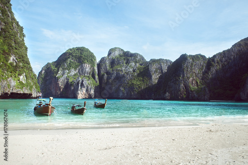  Beach with white sand landscape. Boat mooring in Asian style, canoe. Phi Phi Ley Thailand
