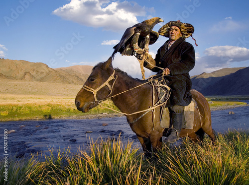 Mongolian man on a horse with an eagle
