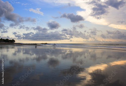 Mirror reflection of the sunset on Kuta beach. The island of Bali. Indonesia.