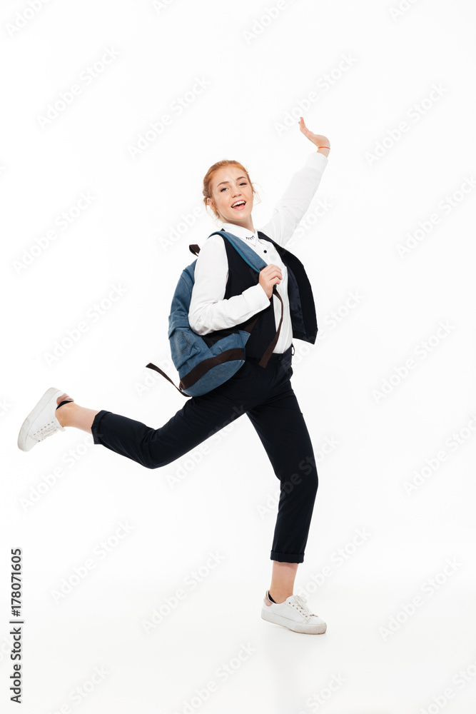 Full length image of happy gigner student woman with backpack