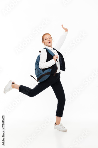 Full length image of happy gigner student woman with backpack