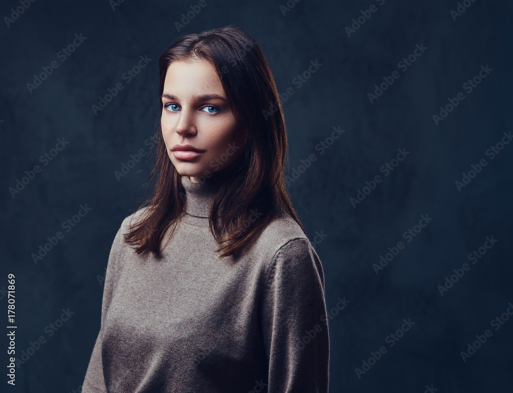 A woman dressed in a long neck brown jacket. A woman dressed in a long neck brown jacket.