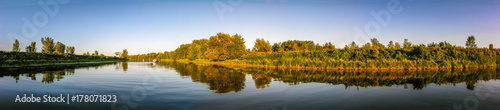 Panoramic view of a river with boat at anchor © Guy