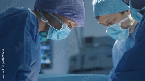 Close up Shot of Female Doctor Performing Surgical Operation in Modern Operating Room