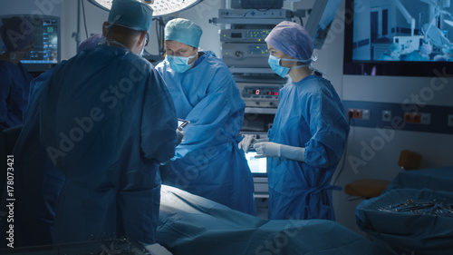 Doctor using Tablet in Operating Room.