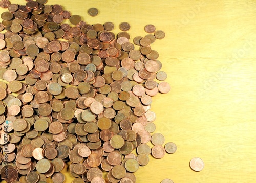 Pile of coins of euro cents on wooden background