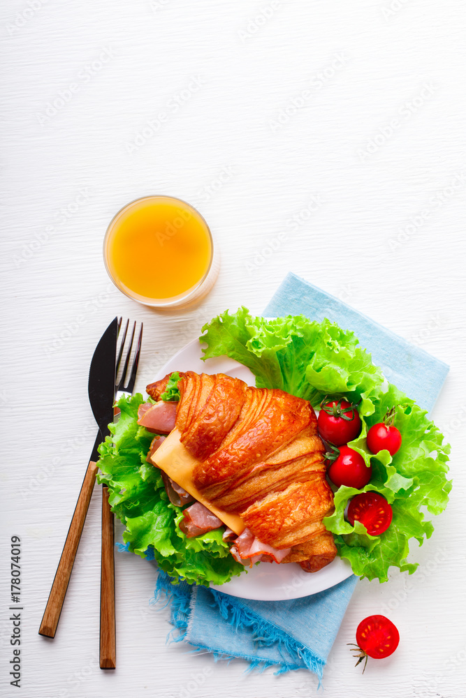 Fresh Croissant Sandwich with Ham, Cheese,Cherry tomatoes and Salad leaf with Coffee and a glass of Juice Breakfast in bed Delicious Baking Light Meal Fresh Croissant Sandwich with Ham, Cheese,Cherry tomatoes and Salad leaf with Coffee and a glass of Juice Breakfast in bed Delicious Baking Light Meal