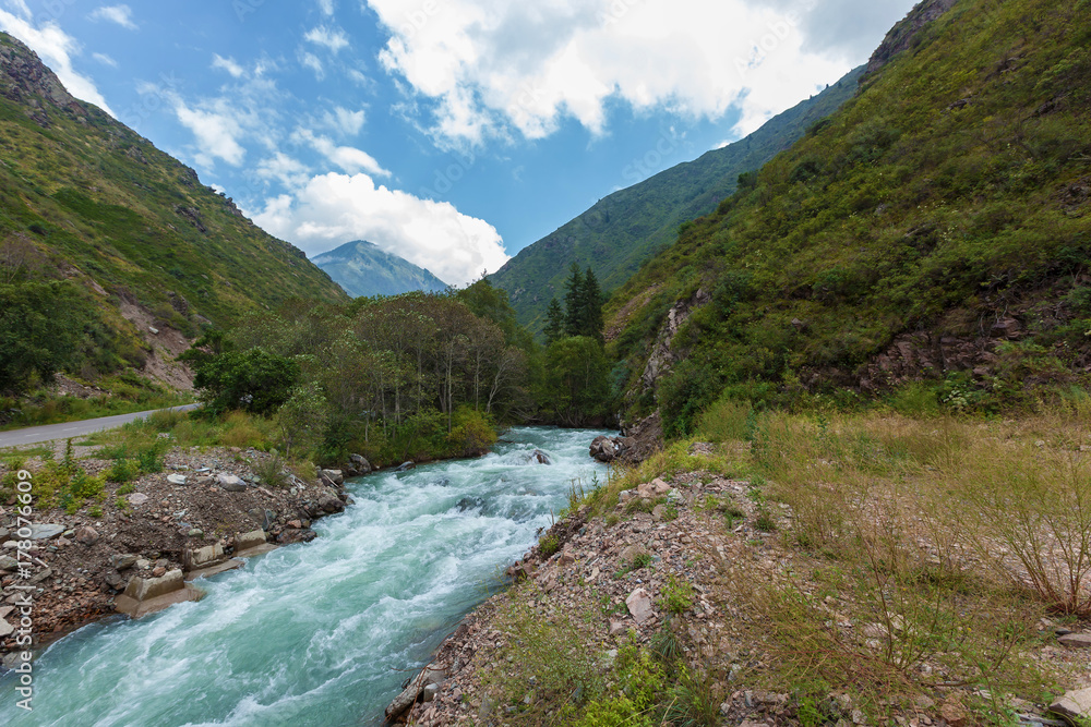 Fast river stream in a mountain forest between two mountains. Beautiful river in forest nature. . Big river in in the mountains Wild nature of Kazakhstan. Fast river stream in a mountain forest between two mountains. Beautiful river in forest nature. . Big river in in the mountains Wild nature of Kazakhstan.