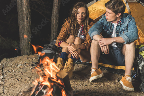hikers sitting next to campfire