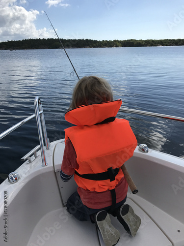 Youngster fishing from boat