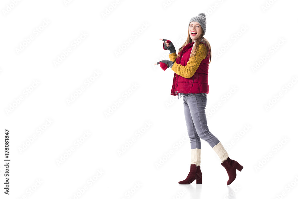 woman in winter clothes pointing at something woman in winter clothes pointing at something