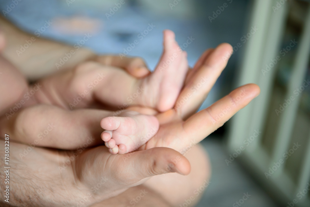 Children's feet in hands of father. Children's feet in hands of father.
