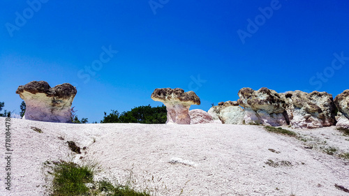 Stone mushrooms in Bulgaria under blue sky.