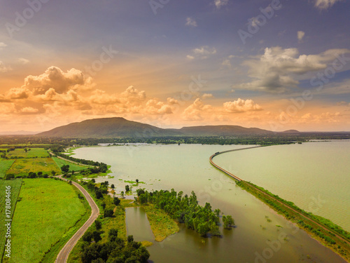 The road traverses along the edge of the reservoir The railroad crosses the reservoir is unseen Thailand.