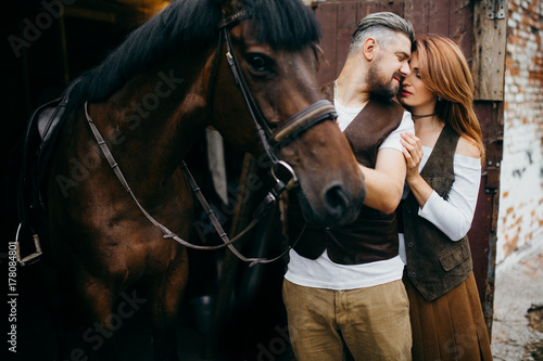 Beautiful couple with horse in the stables © shunevich