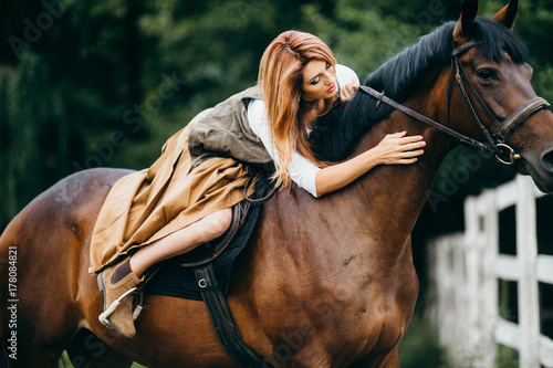 Fototapeta Naklejka Na Ścianę i Meble -  Beautiful couple with horse in the stables