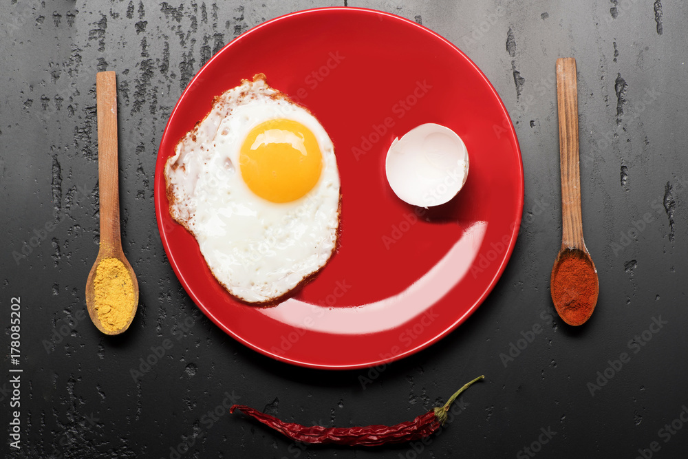 Food placed on red plate on black background, top view Food placed on red plate on black background, top view