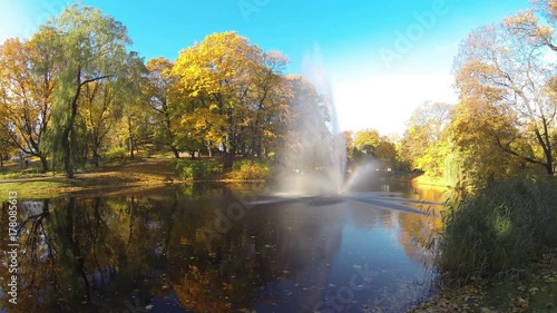 timelapse of the Fountain and rainbow in Riga Canal that flows through Bastion park autumn background with colored leaves (Bastejkalns). Latvia autumn photo