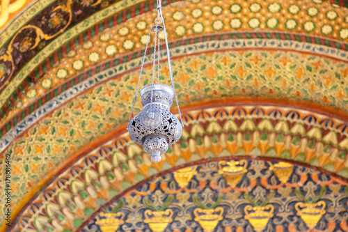 An old lamp on a blurred ornament background. Shallow depth of field. Entrance to the Etchmiadzin Cathedral. Armenia photo